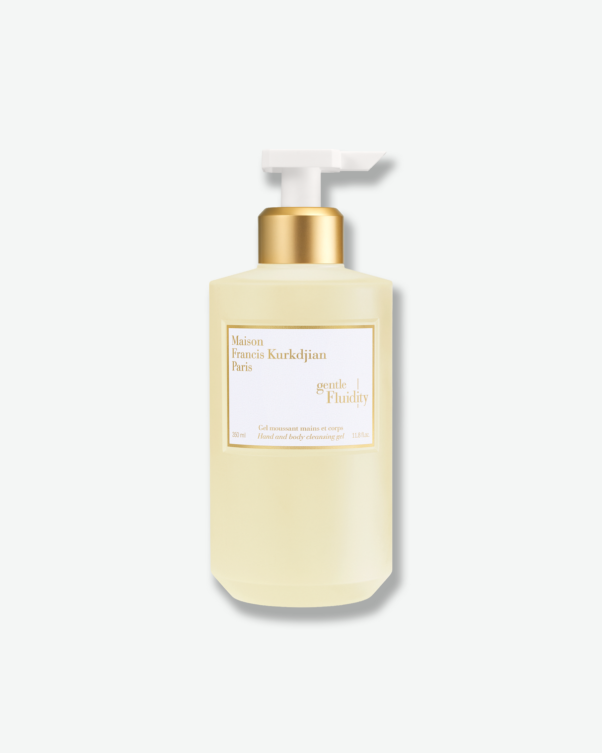 Maison Francis Kurkdjian Gentle Fluidity Hand & Body Cleansing Gel in a pale golden pump bottle with white-and-gold labeling.