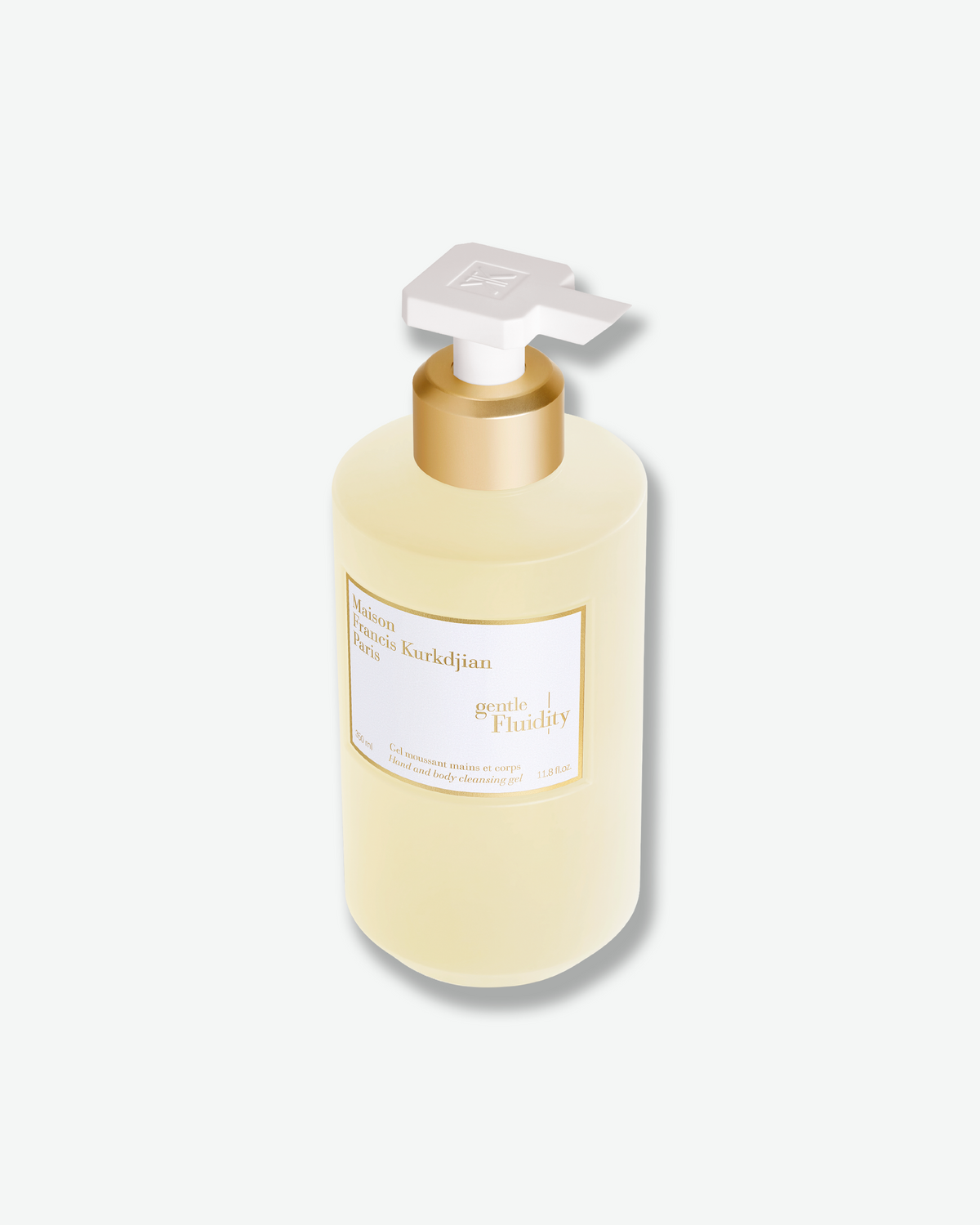 Angled view of the Maison Francis Kurkdjian Gentle Fluidity Hand & Body Cleansing Gel, featuring its white pump and polished gold collar.