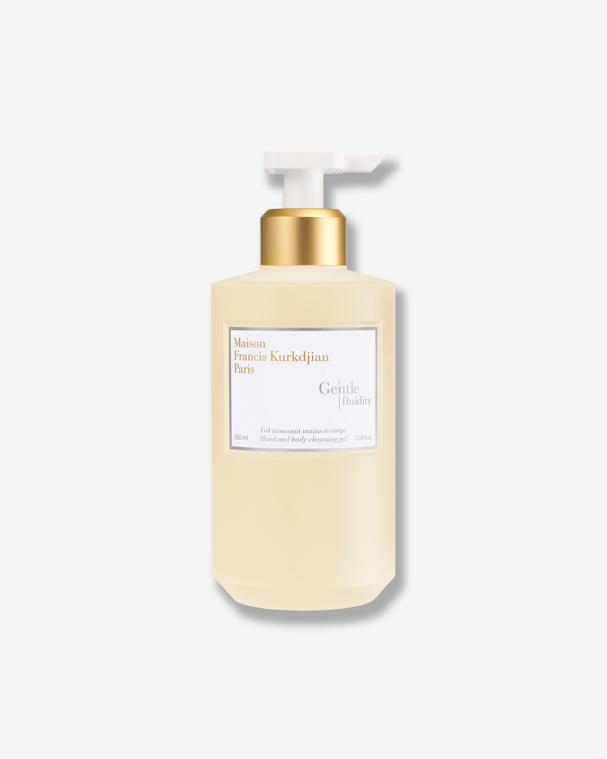 Maison Francis Kurkdjian Gentle Fluidity Hand & Body Cleansing Gel in a pale golden pump bottle with white-and-gold labeling.