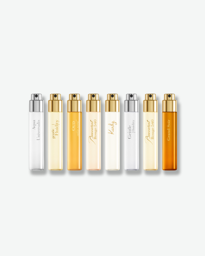 Maison Francis Kurkdjian The Fragrance Wardrobe Essentials discovery set featuring eight 11 mL perfume travel sprays in a row on a plain white background.