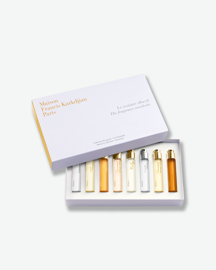 Set of miniature perfume bottles in a box with 'Maison Francis Kurkdjian' branding on a white background.
