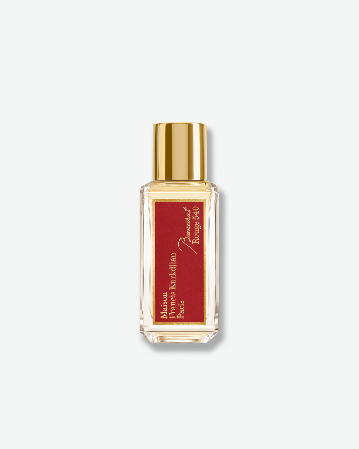 Maison Francis Kurkdjian Baccarat Rouge 540 scented body oil in a clear glass bottle with a shiny gold cap and red label.