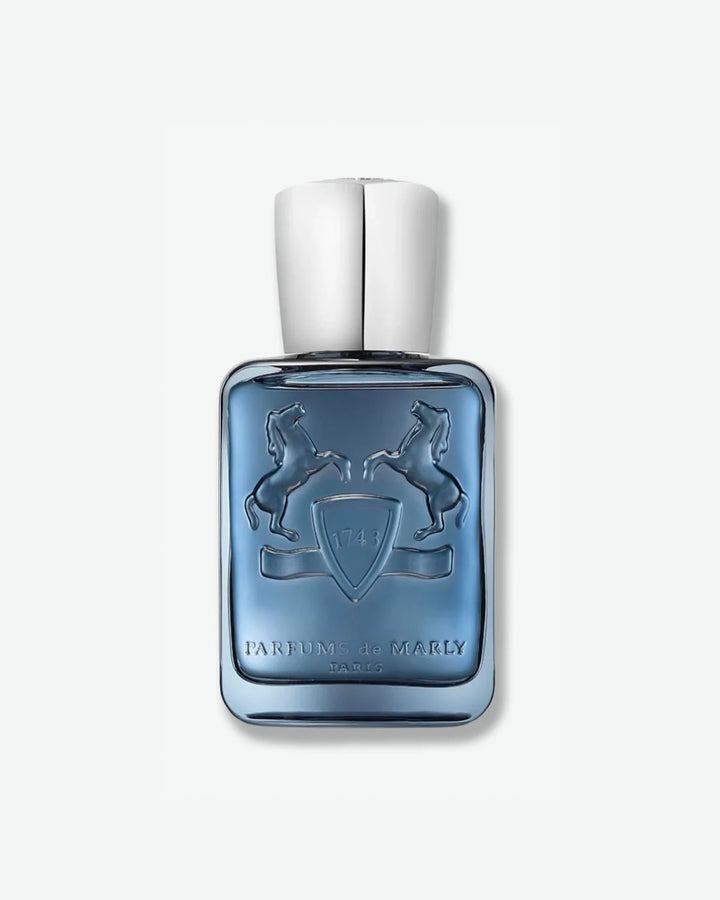 Blue perfume bottle with silver cap on a white background