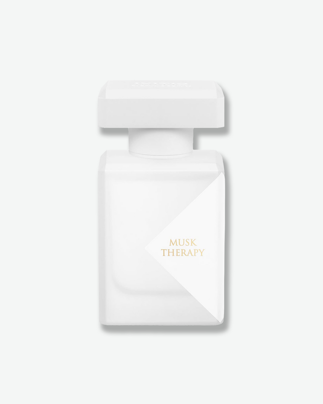 White perfume bottle with 'Musk Therapy' text on a light gray background