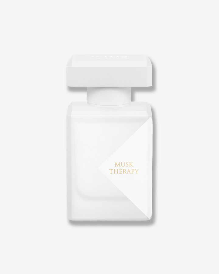 White perfume bottle with 'Musk Therapy' text on a light gray background