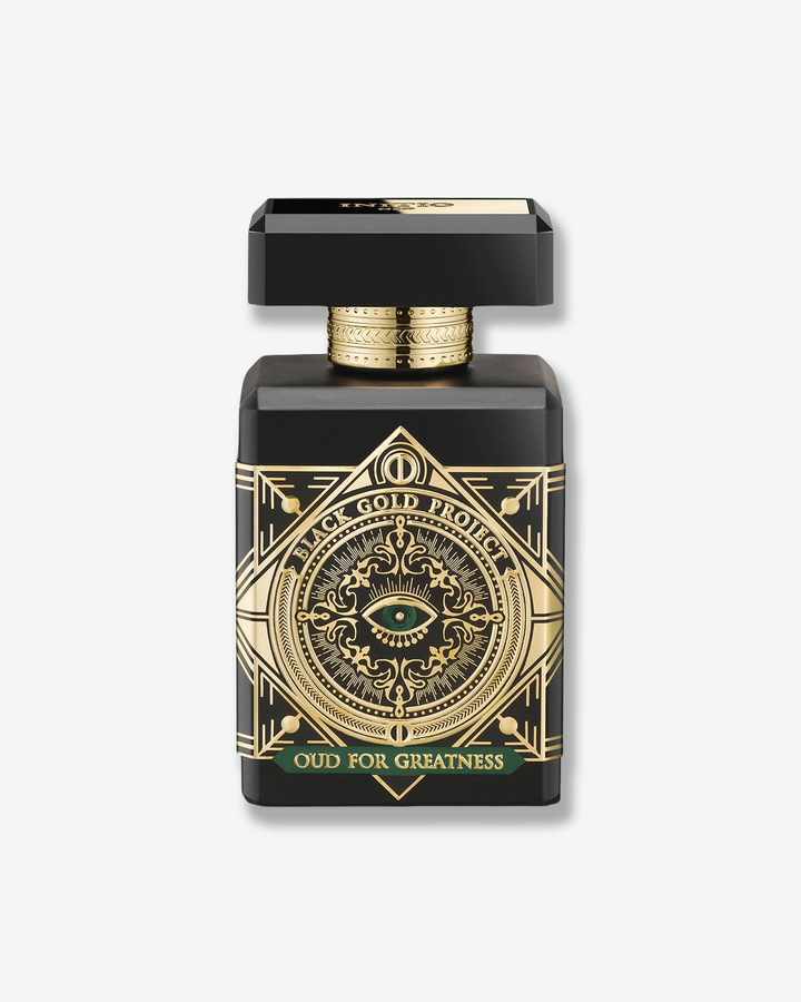 Perfume bottle with intricate gold design on a white background