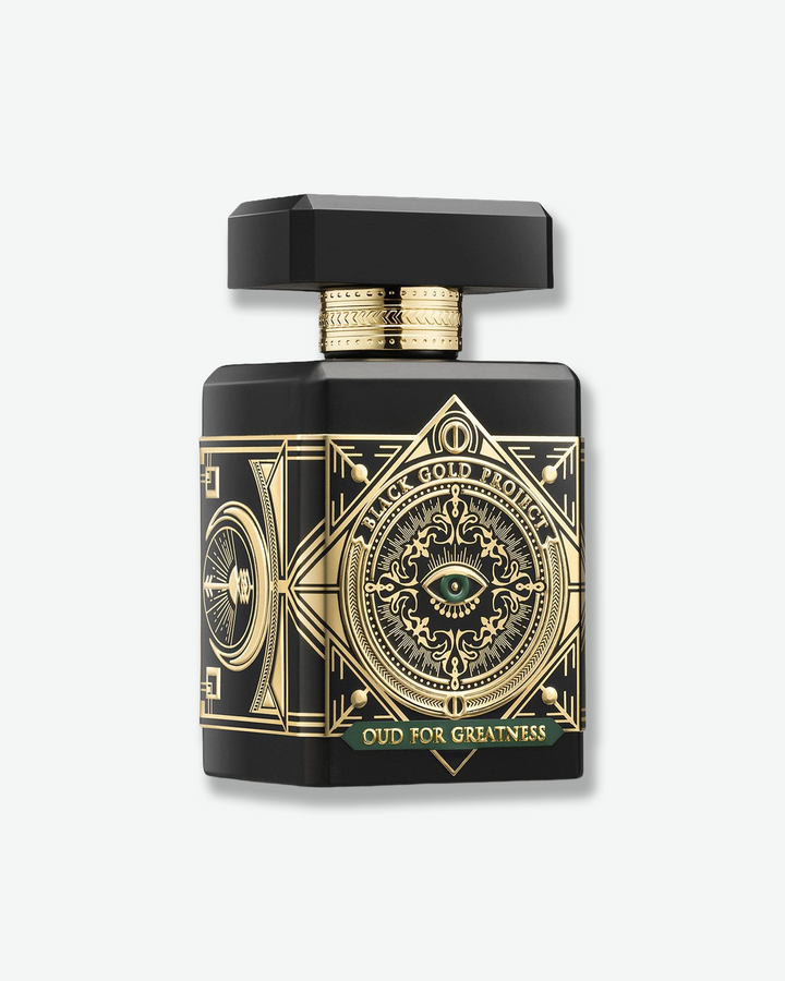 Black and gold perfume bottle with intricate design on a white background