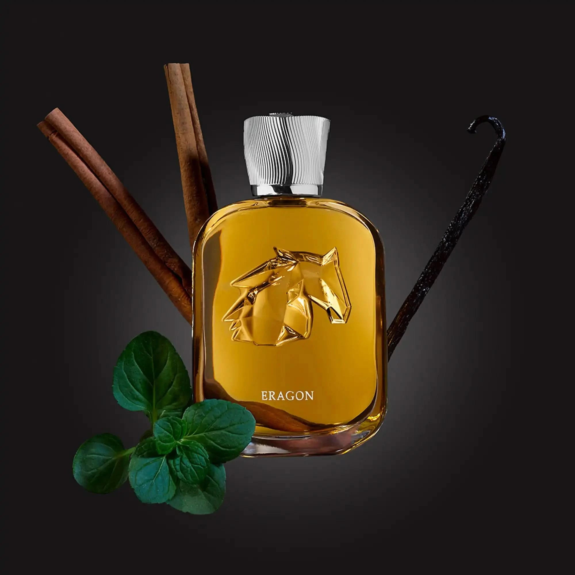 Perfume bottle with horse emblem labeled 'Eragon' surrounded by vanilla beans and mint leaves on a dark background