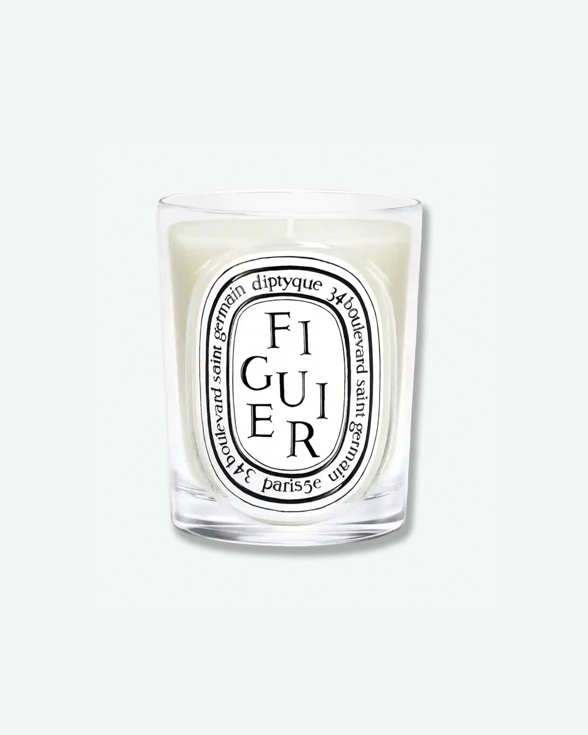 Diptyque Figuier scented candle in a classic clear glass jar featuring the signature white oval logo with black lettering, isolated on a light grey background.