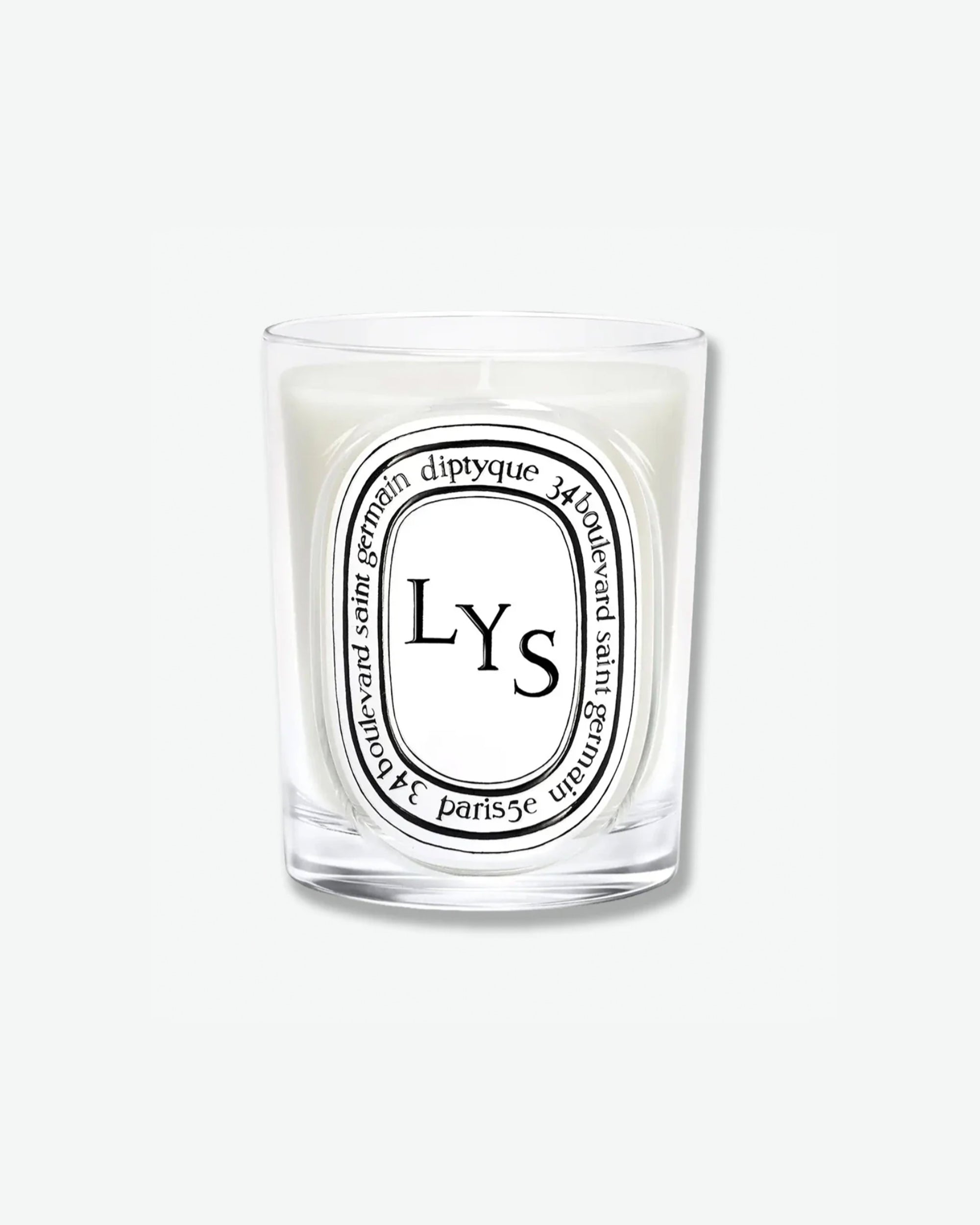 Diptyque Lys scented candle in a classic clear glass jar featuring the signature white oval logo with black lettering, isolated on a light grey background.