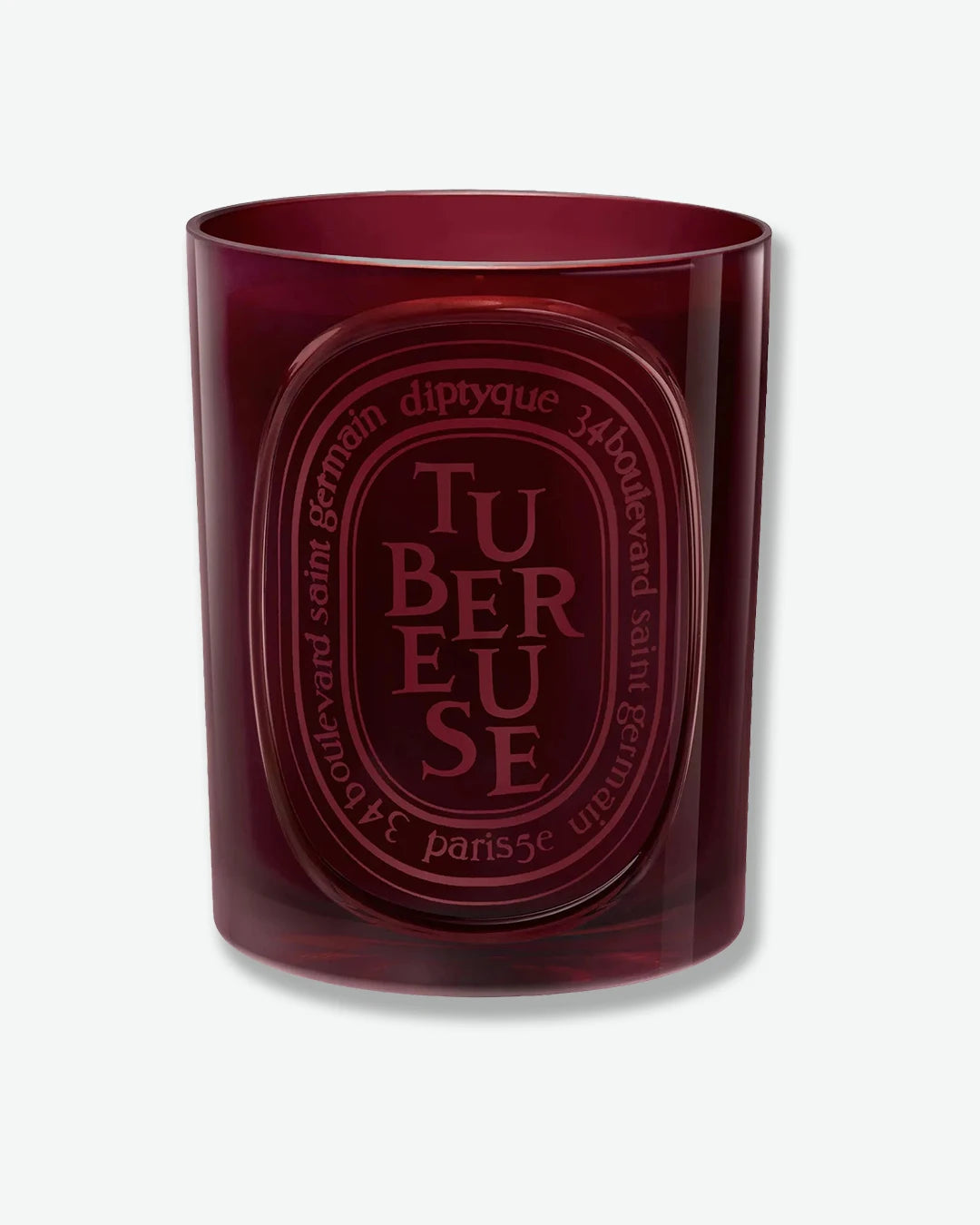 Diptyque tubereuse candle in a red glass container on a white background