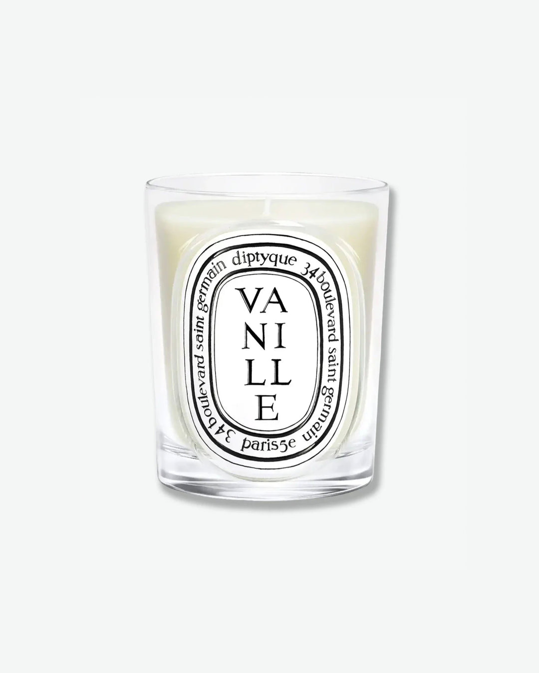 Diptyque Vanille scented candle in a classic clear glass jar featuring the signature white oval logo with black lettering, isolated on a light grey background.