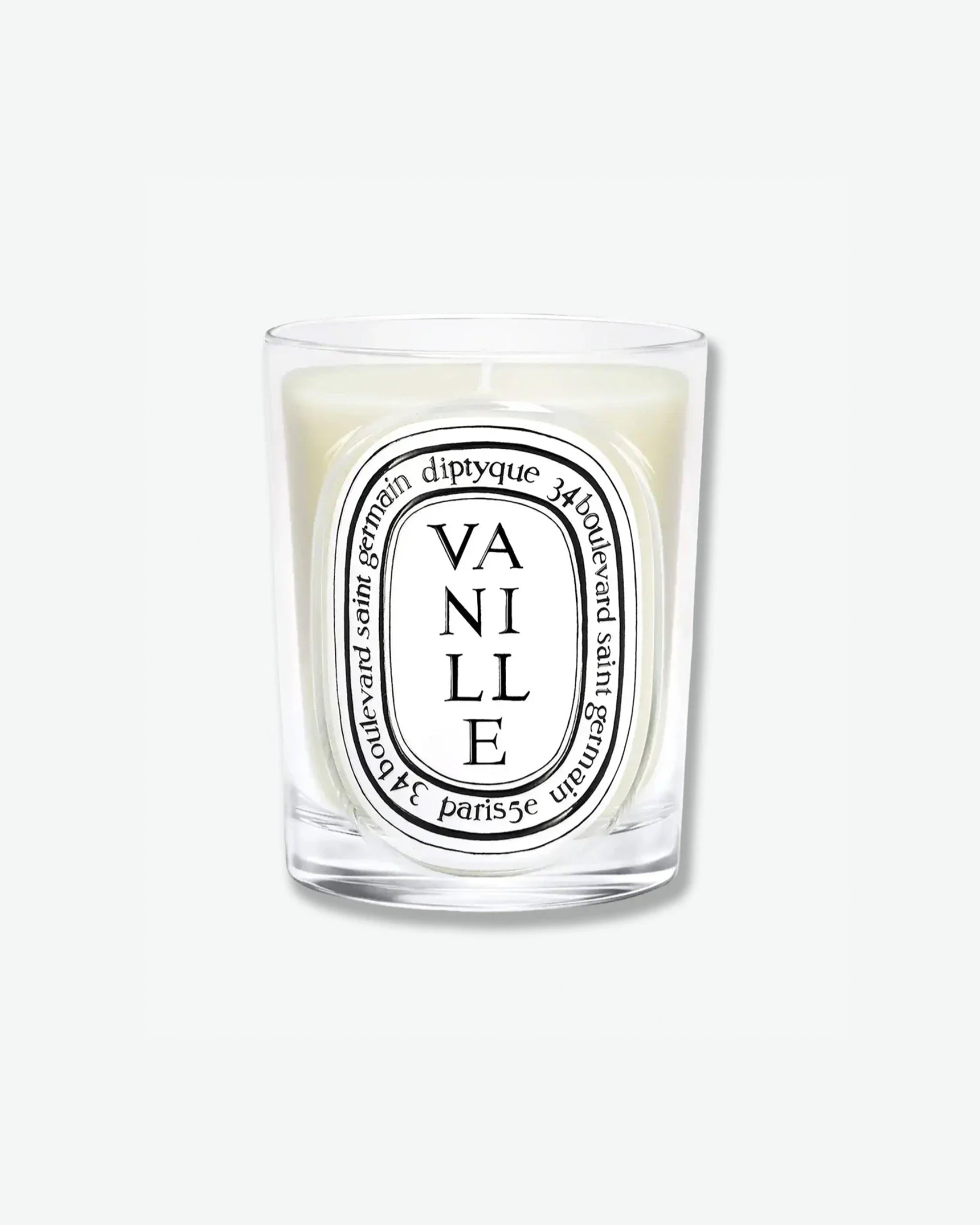 Diptyque Vanille scented candle in a classic clear glass jar featuring the signature white oval logo with black lettering, isolated on a light grey background.