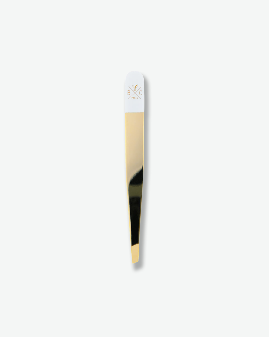 Luxury gold and white slanted tweezers isolated on a plain white background.