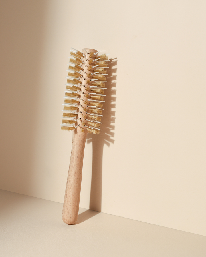 Wooden hairbrush on a beige background