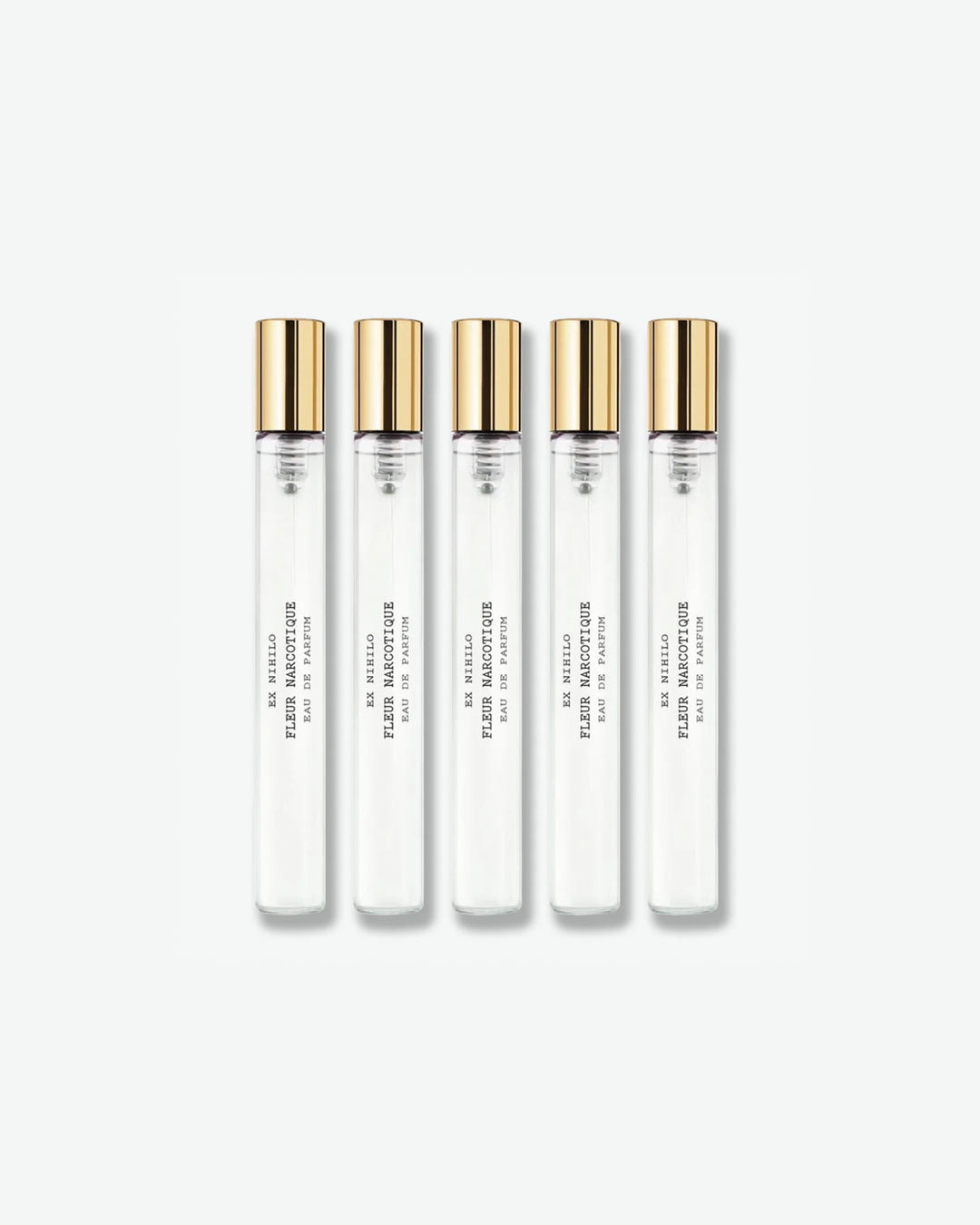 A set of five identical Ex Nihilo Fleur Narcotique Eau de Parfum travel spray vials with clear glass bodies and gold caps, lined up vertically against a light grey background.