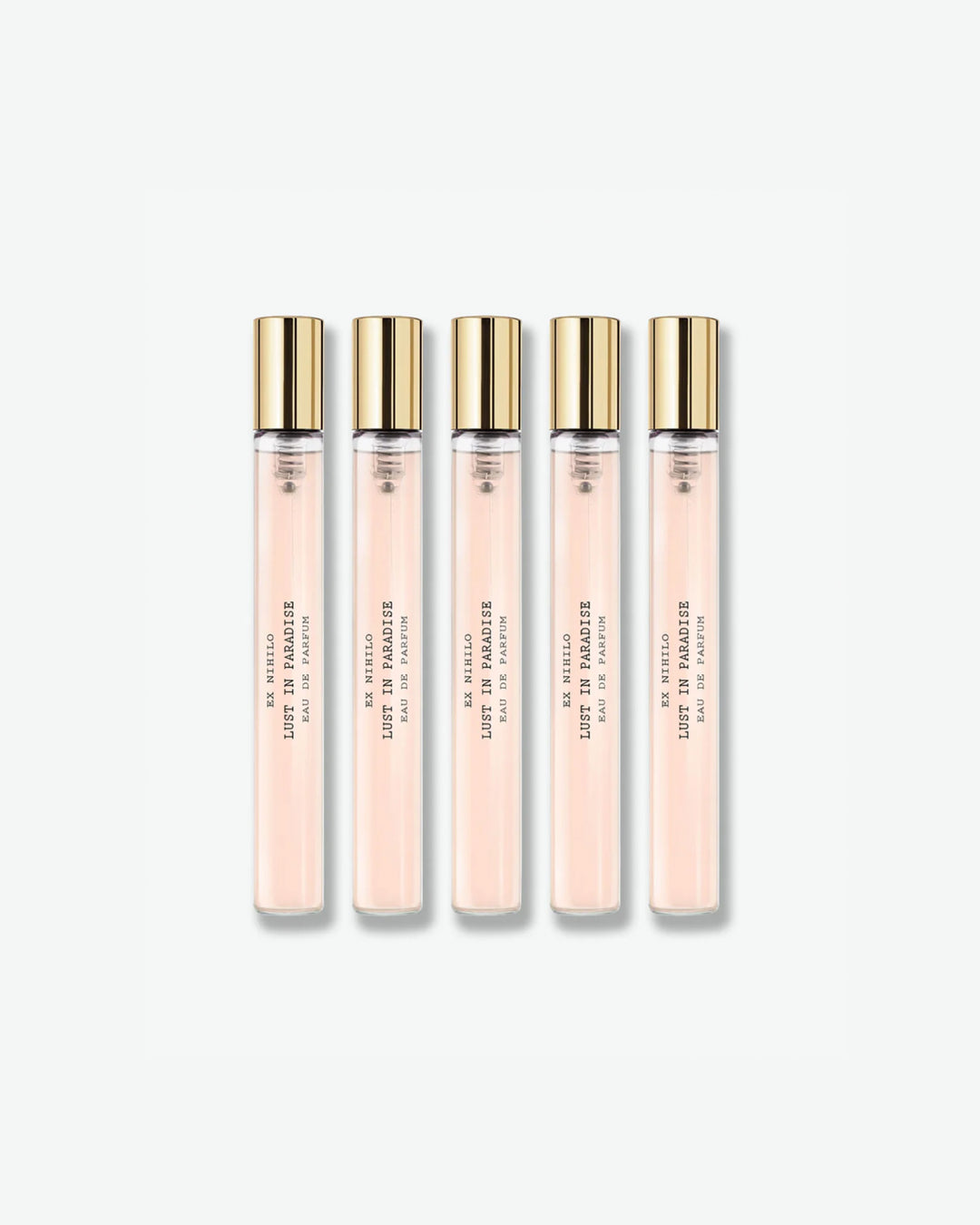 A set of five identical Ex Nihilo Lust in Paradise Eau de Parfum travel spray vials showing a light pink liquid formula inside clear glass tubes with gold caps, isolated on a light grey background.