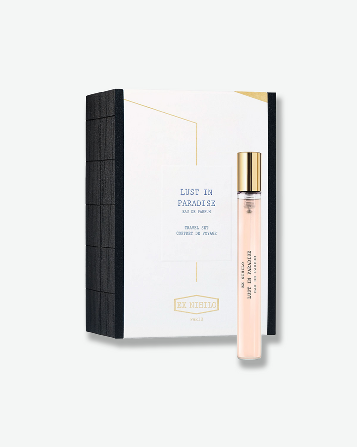 Perfume bottle and packaging with 'Lust in Paradise' branding on a white background