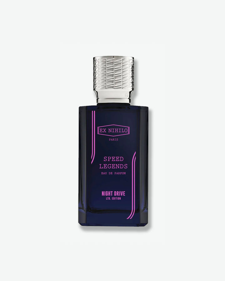 Ex Nihilo Speed Legends Night Drive Limited Edition Eau de Parfum in a sleek, deep translucent navy blue bottle featuring a bright pink logo and lettering, topped with an intricately engraved silver cap, isolated on a light grey background.