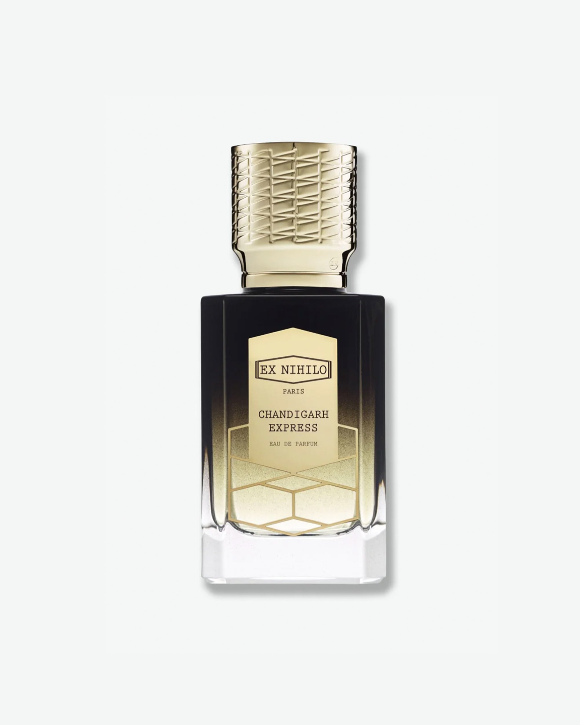 Product shot of Ex Nihilo Chandigarh Express Eau de Parfum. The rectangular glass bottle features a striking translucent-to-dark black gradient design, revealing a golden shimmer at the bottom. It is topped with an ornate gold cap engraved with a textured lattice design and finished with an elegant gold-framed geometric label.