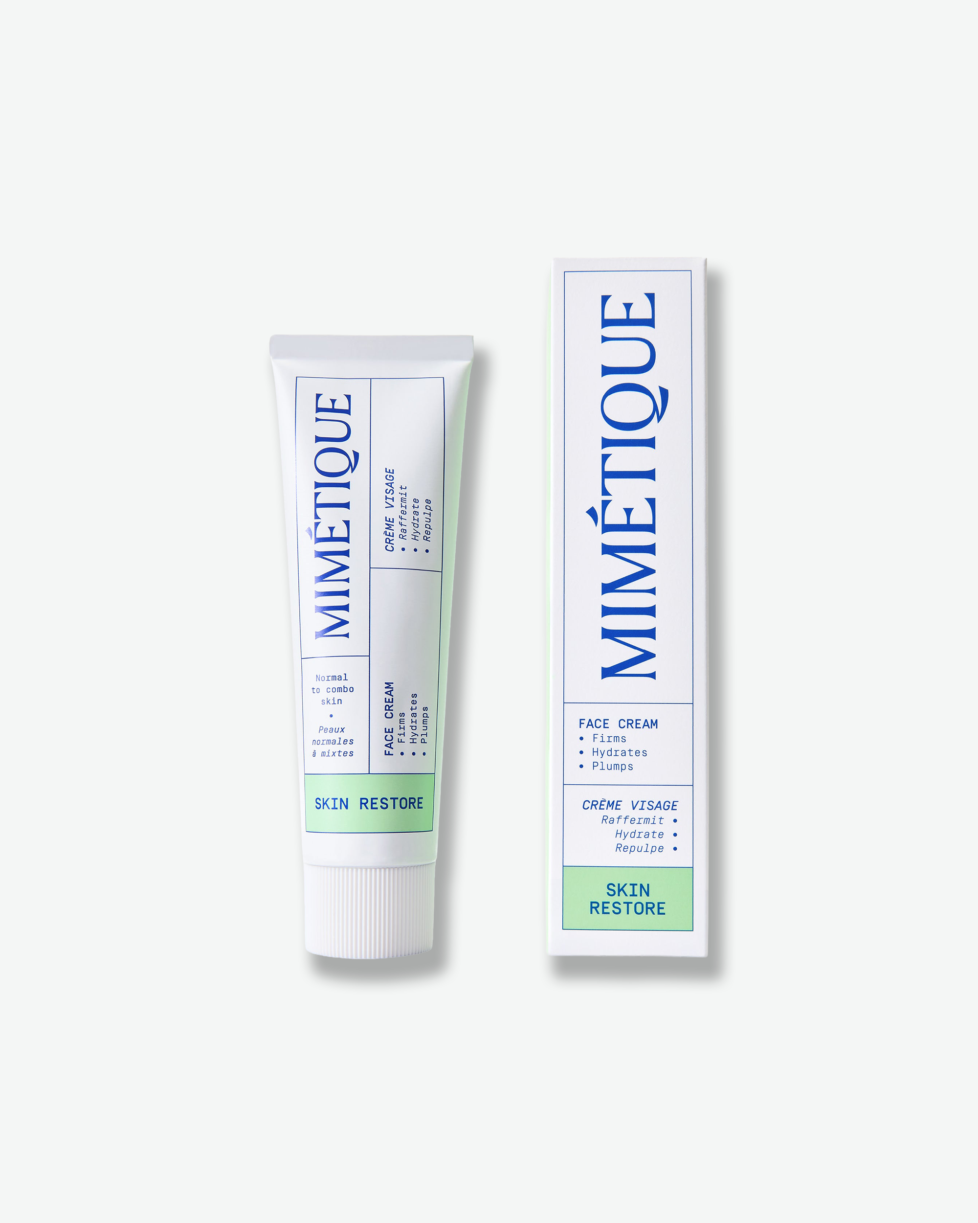 A tube and box of Mimétique Skin Restore Face Cream, shown on a clean off-white background. The packaging features a white base with blue text and borders, and a light green block at the bottom.