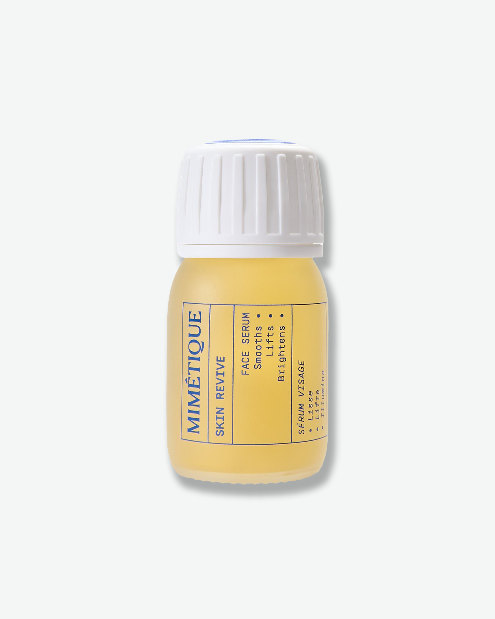 A small bottle of Mimétique Skin Revive serum with a white ribbed cap and a pale yellow liquid inside, set against a clean, light gray background.