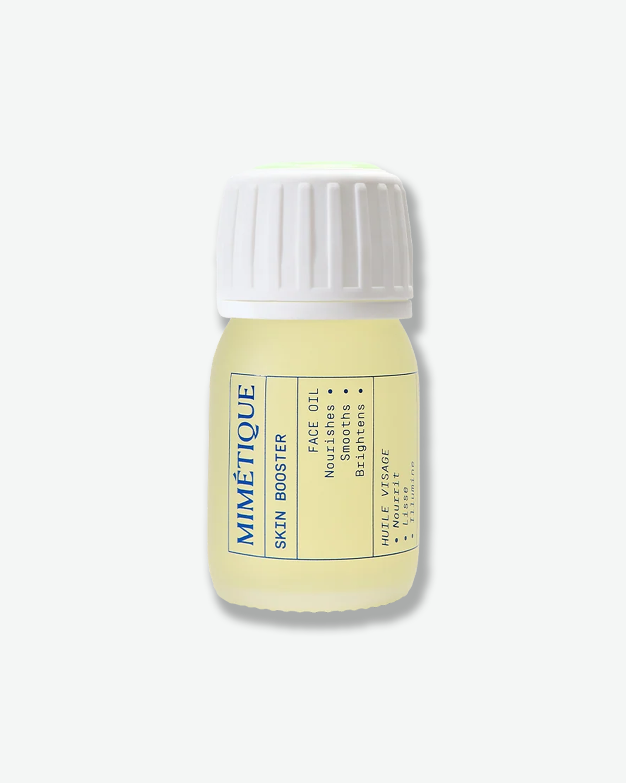 A small Mimétique skin booster face oil bottle with a white ribbed cap and pale yellow liquid inside, shown on a clean off-white background.