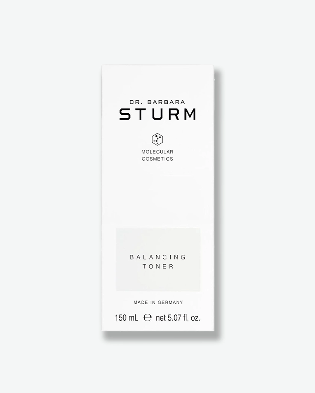 A product shot of the white cardboard packaging box for the Dr. Barbara Sturm Balancing Toner, centered against a light gray background. It features clean black branding and a light gray rectangle highlighting the text "BALANCING TONER". The bottom indicates "MADE IN GERMANY" and the volume "150 mL e net 5.07 fl. oz."