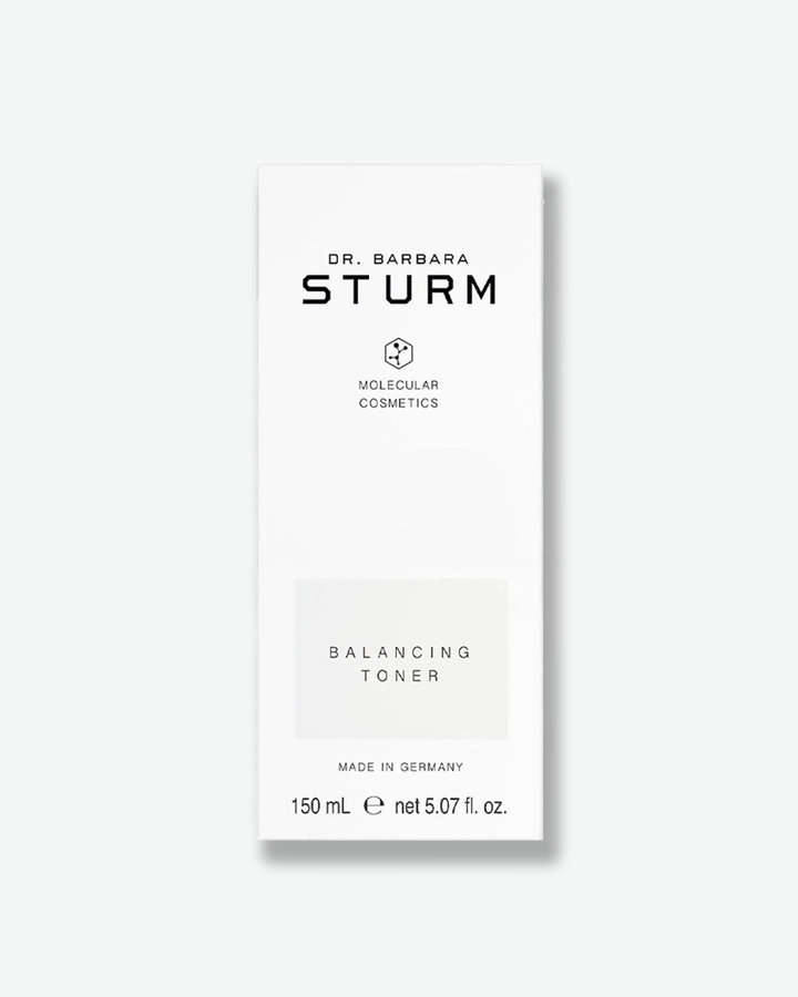 A product shot of the white cardboard packaging box for the Dr. Barbara Sturm Balancing Toner, centered against a light gray background. It features clean black branding and a light gray rectangle highlighting the text "BALANCING TONER". The bottom indicates "MADE IN GERMANY" and the volume "150 mL e net 5.07 fl. oz."