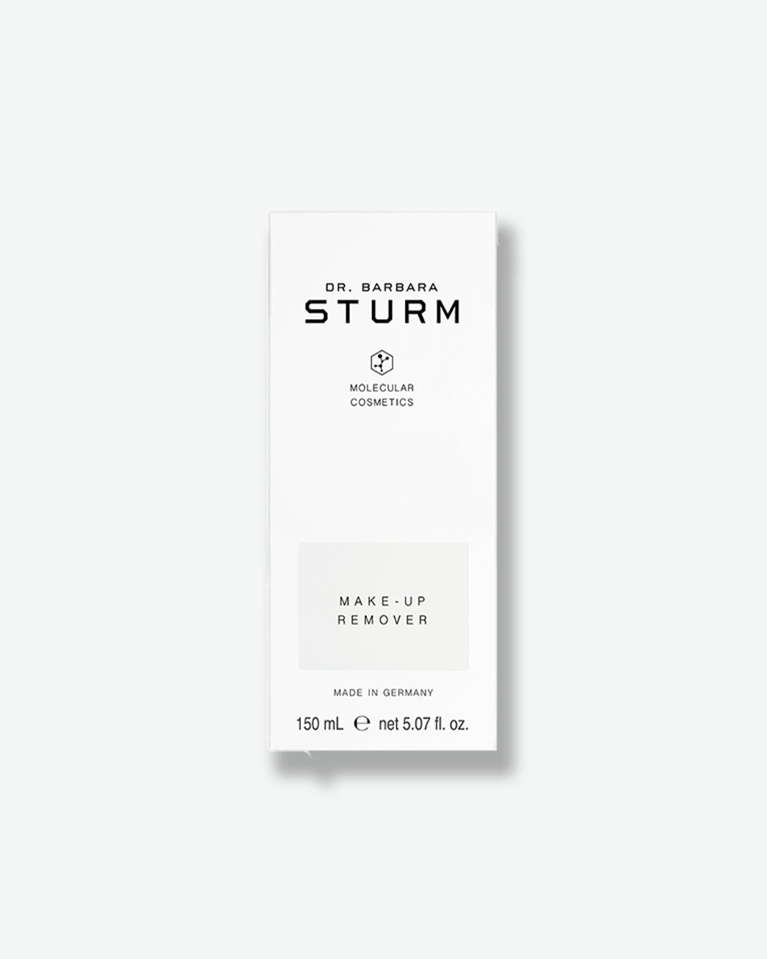 A product shot of the white cardboard packaging box for the Dr. Barbara Sturm Make-Up Remover, centered against a light gray background. It features the same minimalist black branding and logo as the bottle, with a light gray rectangle highlighting the text "MAKE-UP REMOVER". The bottom of the box specifies "MADE IN GERMANY" and the volume "150 mL e net 5.07 fl. oz."