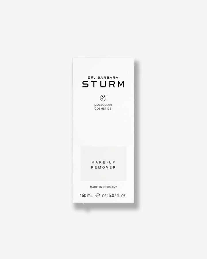 A product shot of the white cardboard packaging box for the Dr. Barbara Sturm Make-Up Remover, centered against a light gray background. It features the same minimalist black branding and logo as the bottle, with a light gray rectangle highlighting the text "MAKE-UP REMOVER". The bottom of the box specifies "MADE IN GERMANY" and the volume "150 mL e net 5.07 fl. oz."