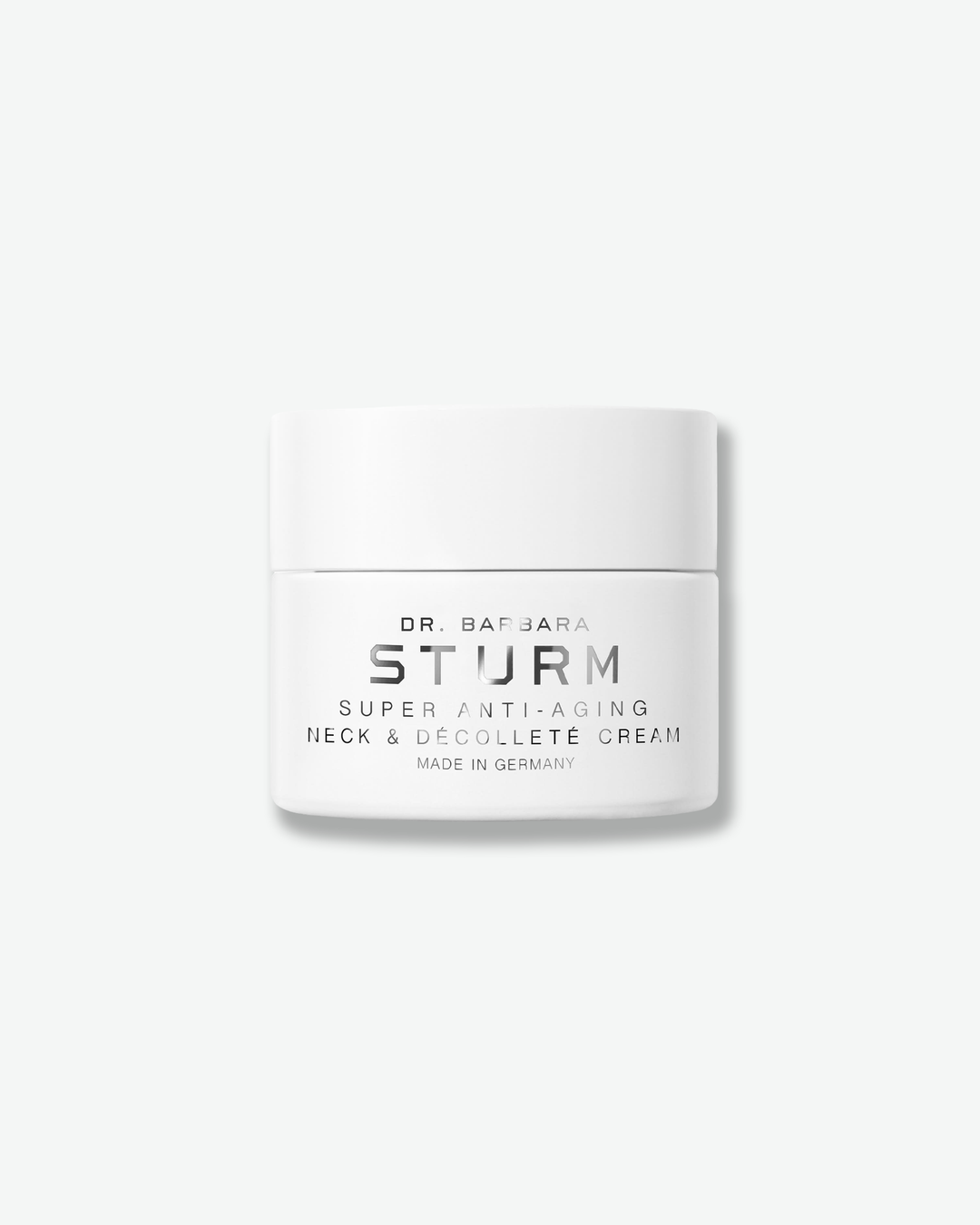 Front view of a Dr. Barbara Sturm Super Anti-Aging Neck & Décolleté Cream jar centered against a plain gray background. The opaque white container displays the product name and "MADE IN GERMANY" in dark grey text, topped with a smooth white cap.
