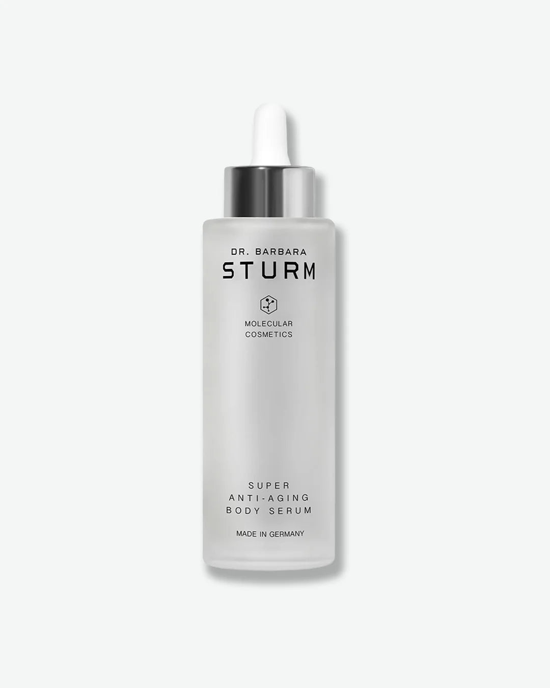 A tall, frosted glass dropper bottle of Dr. Barbara Sturm Super Anti-Aging Body Serum, standing vertically with a metallic silver cap and a white rubber bulb.