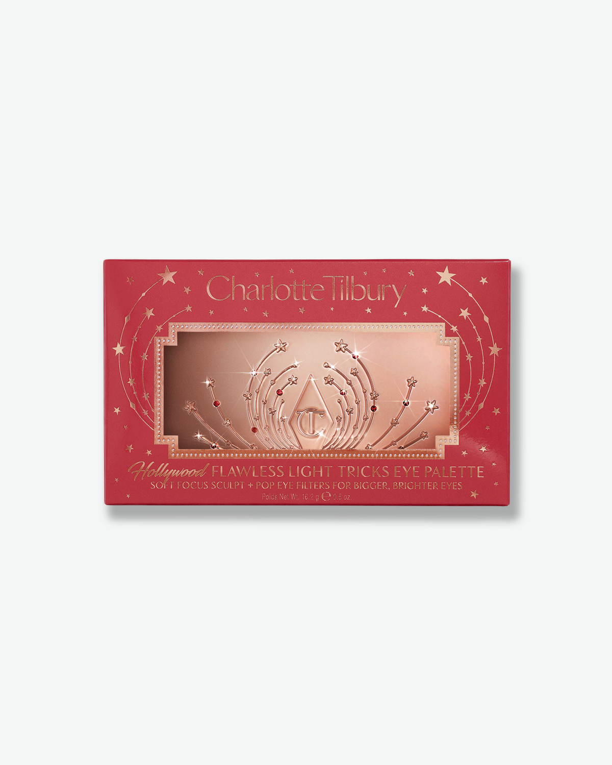 Charlotte Tilbury Hollywood Flawless Light Tricks Eye Palette in festive red and rose gold star-patterned packaging.