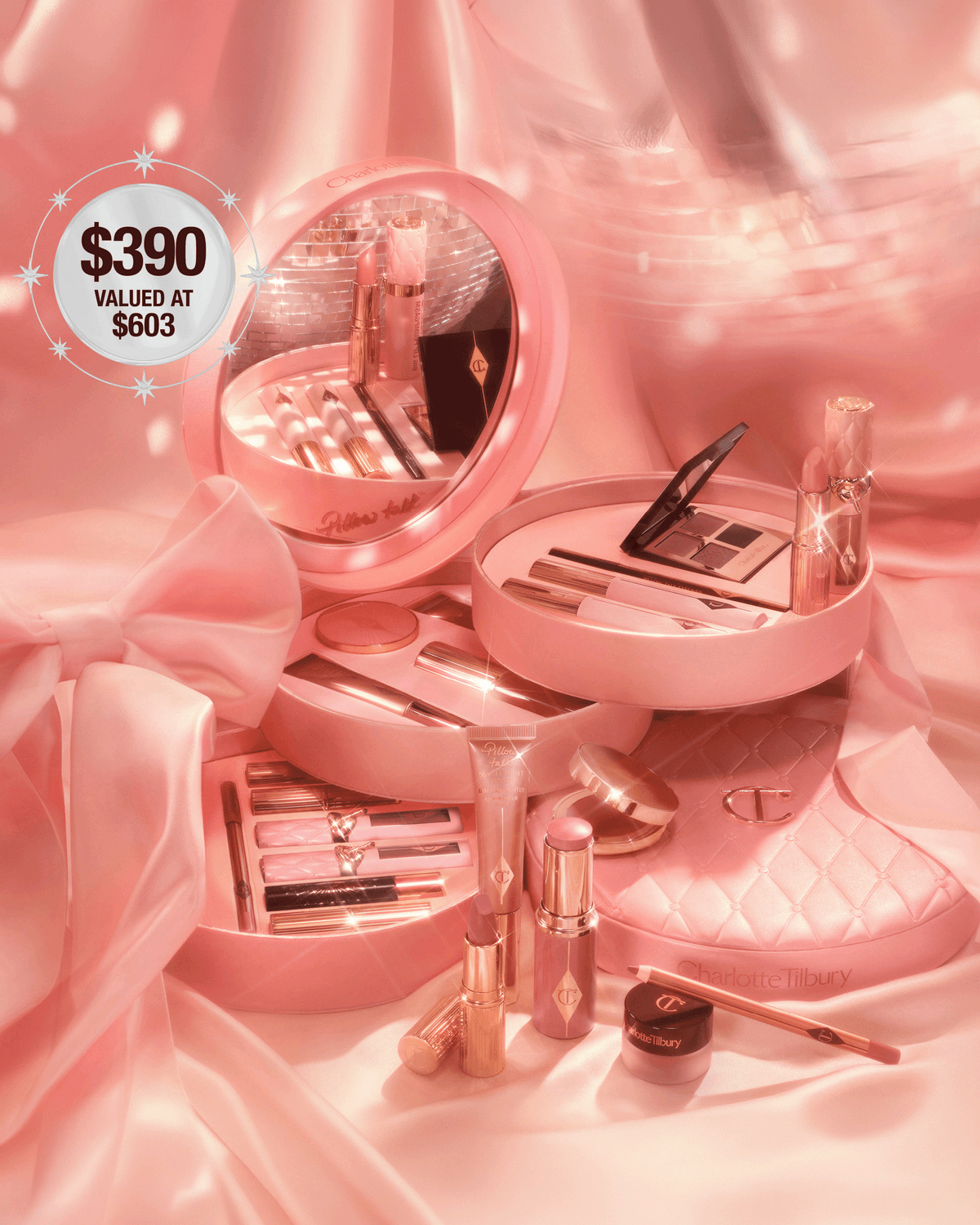 Charlotte Tilbury Pillow Talk Beauty Soulmates collection displayed in pink vanity cases on satin with assorted makeup products.