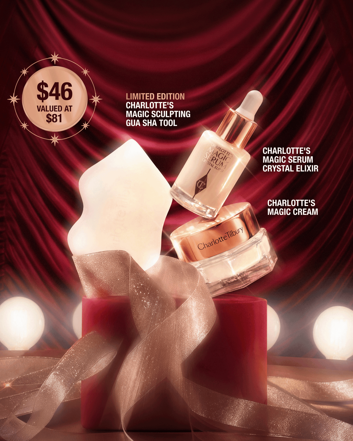 Charlotte’s Iconic Magic Mini Skin Set displayed with Magic Serum, Magic Cream, and a limited-edition sculpting gua sha tool against red velvet.