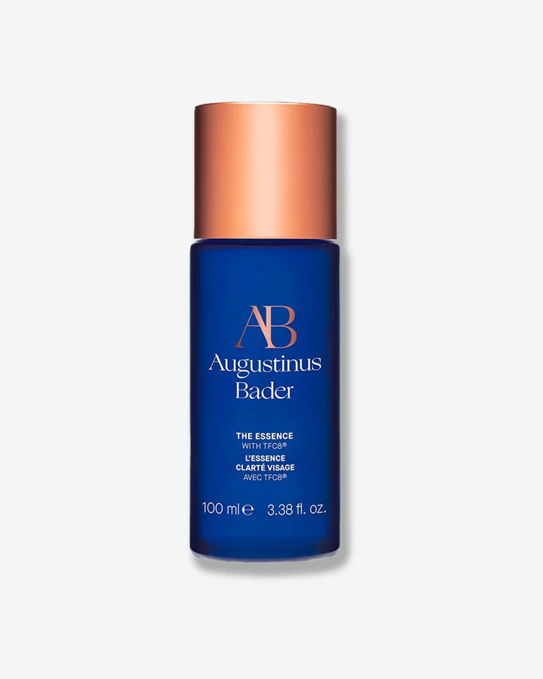 Augustinus Bader The Essence blue cylinder bottle skincare bottle with copper cap on a white background