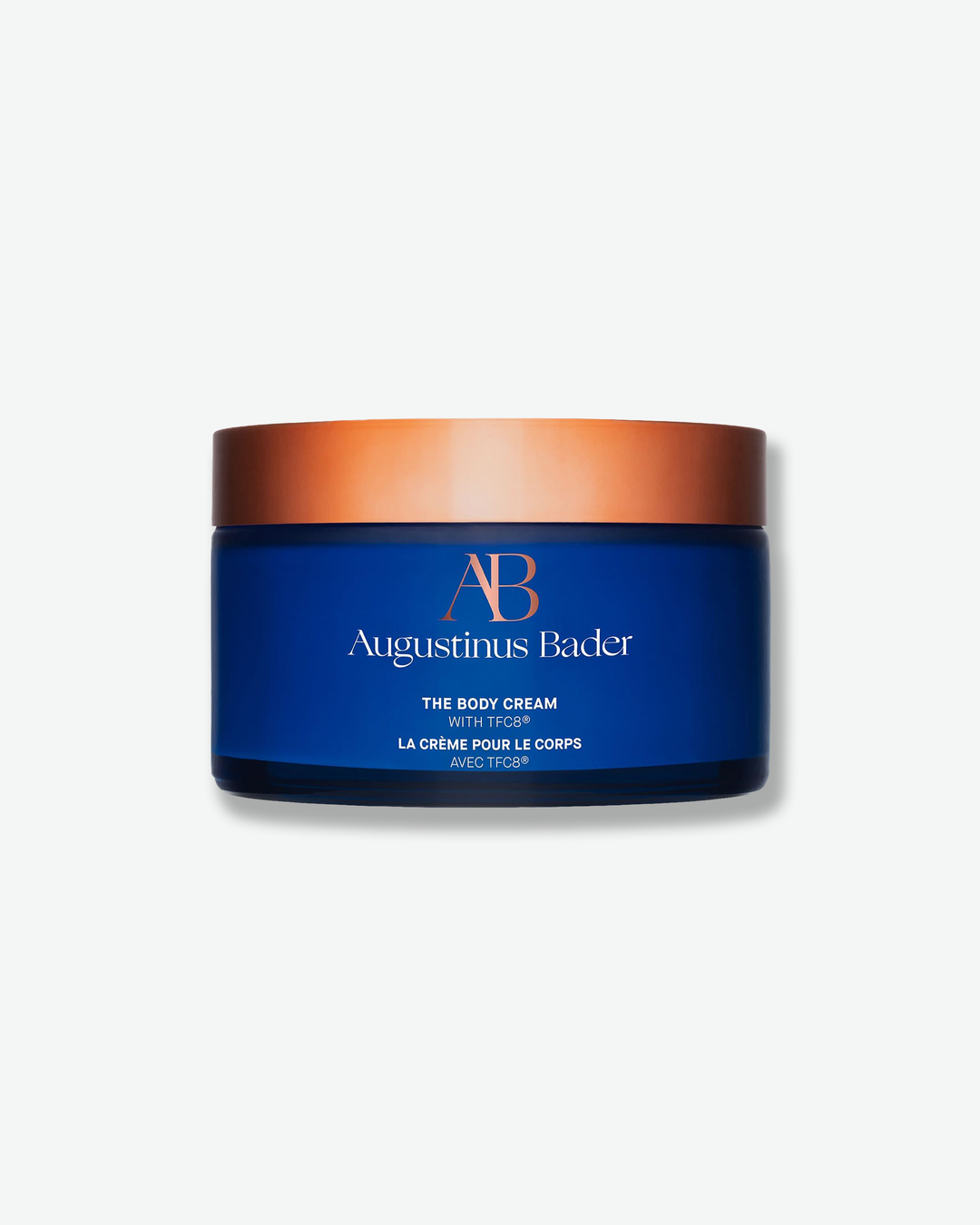 Augustinus Bader body cream jar with blue and bronze design on a white background