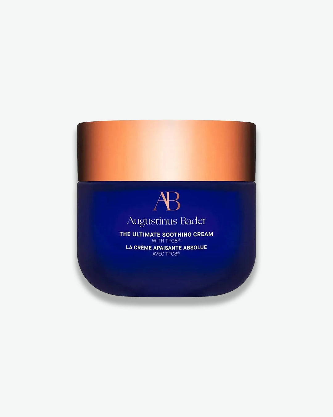 Blue jar with bronze lid of Augustinus Bader cream on a white background
