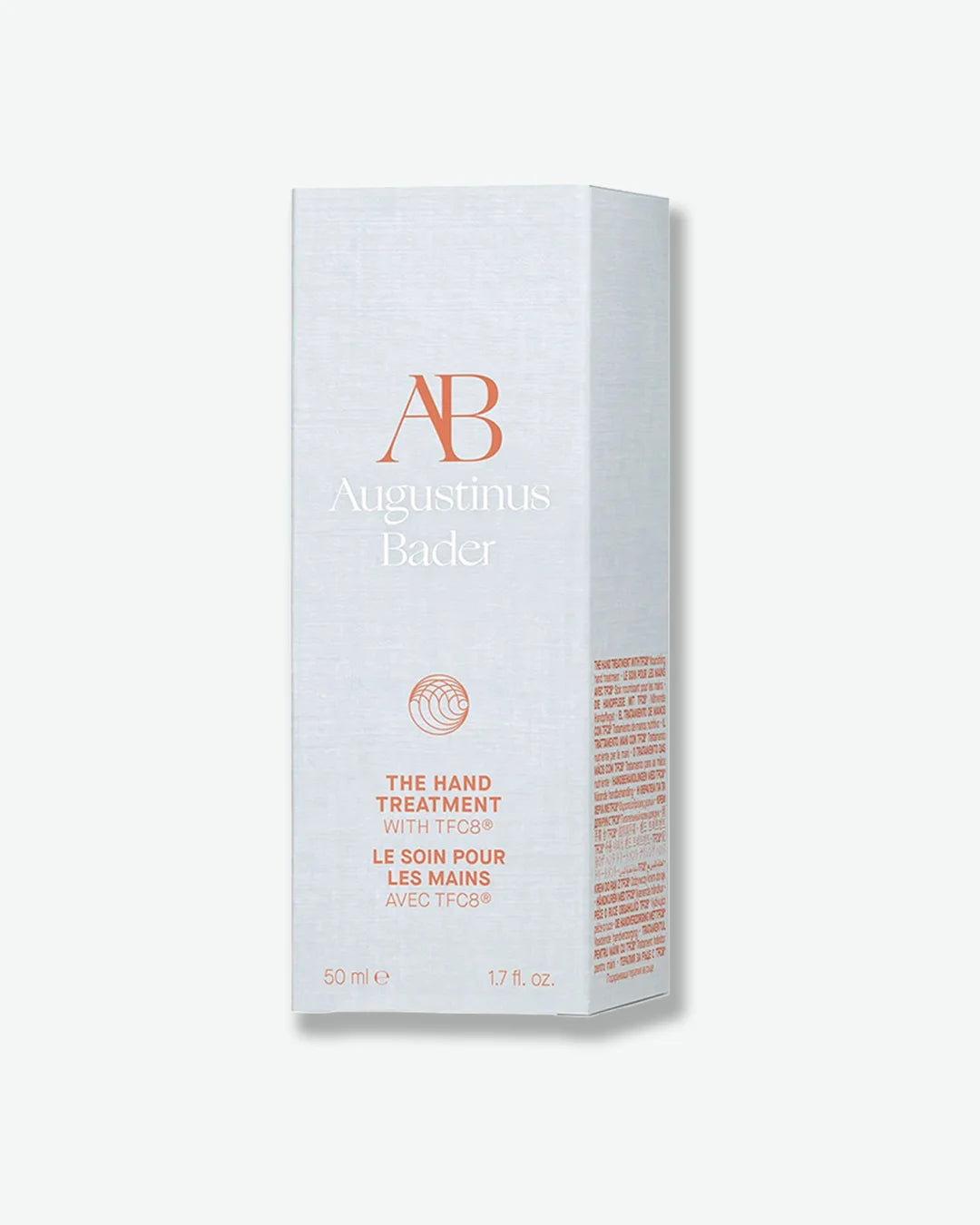 Light gray packaging box of Augustinus Bader The Hand Treatment against a lighter grey background.