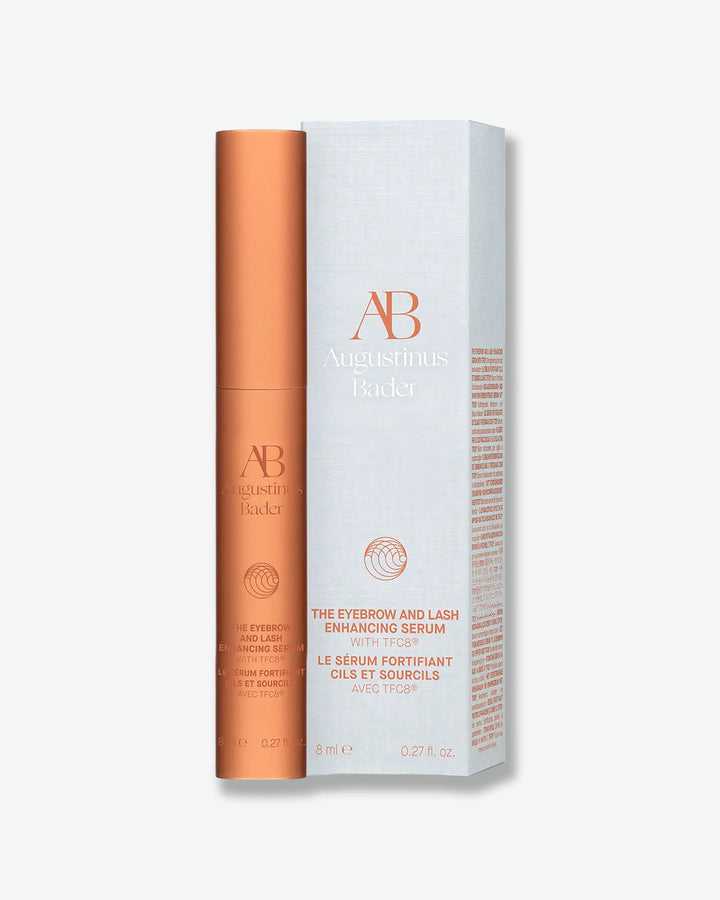 Bronze serum bottle and white box with 'AB' branding on a light gray background