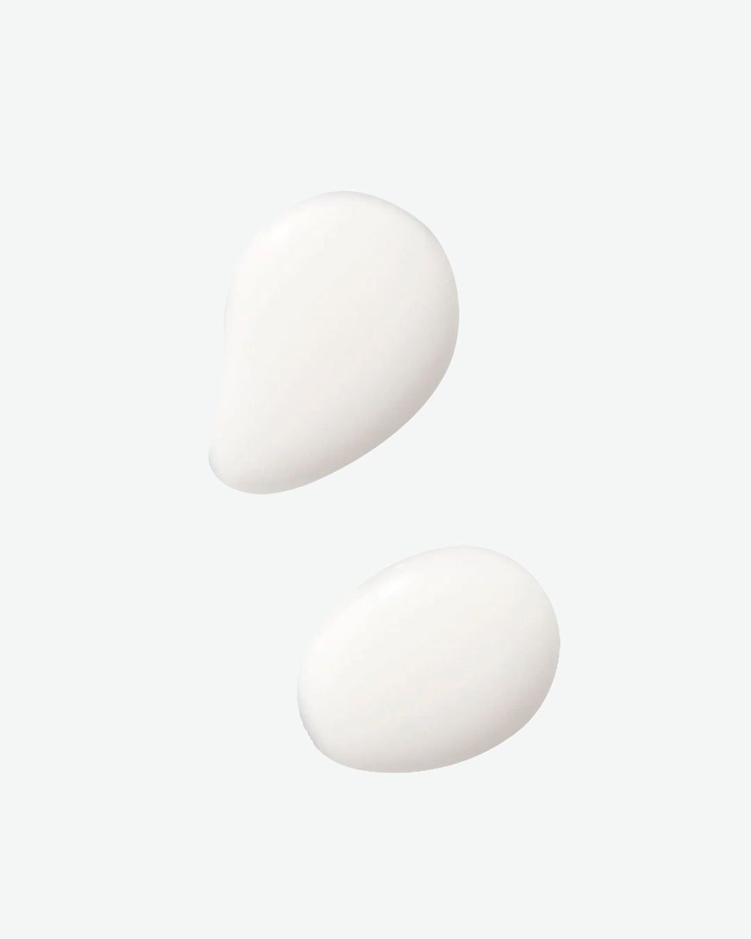 Two white ping pong balls on a light gray background