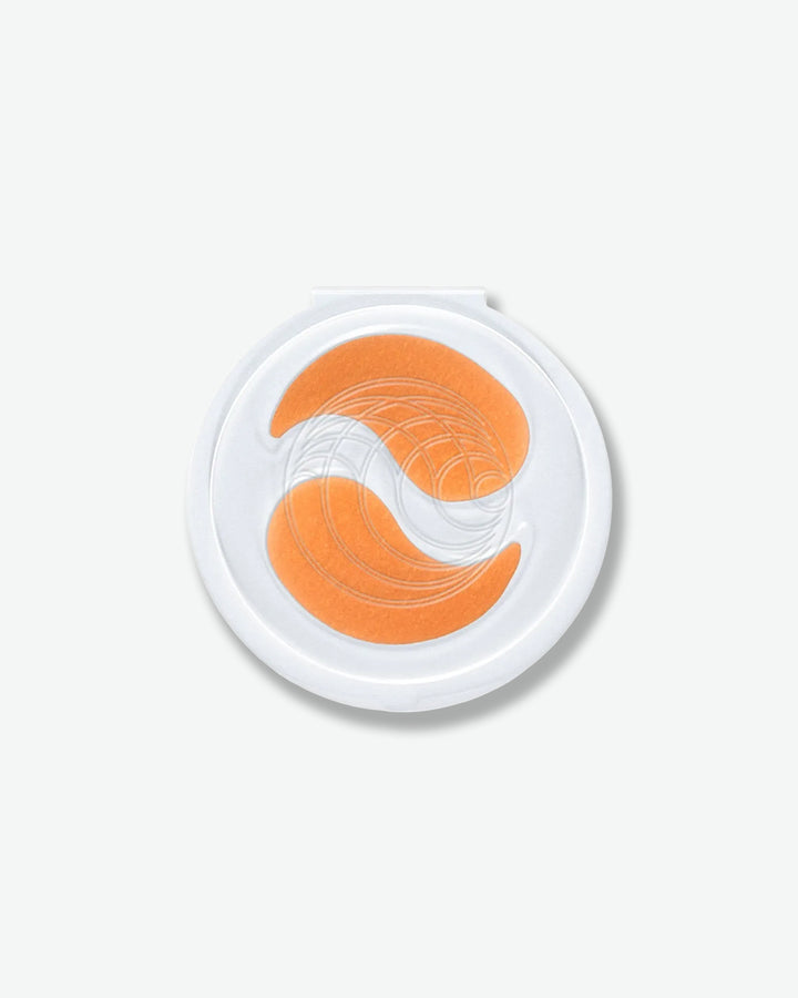 Round container with orange and white design on a white background