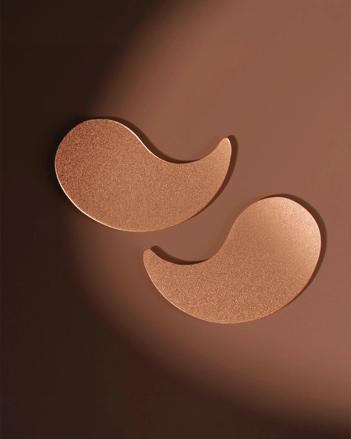 Bronze-colored eye patches on a brown background