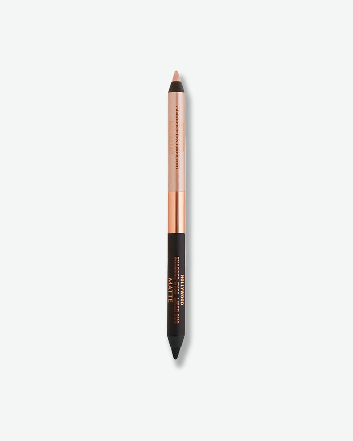 A dual-ended Charlotte Tilbury Hollywood Exagger-Eyes Liner Duo pencil standing vertically, featuring a matte black eyeliner tip on one end and a metallic champagne-gold tip on the other.