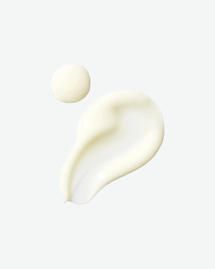 Two droplets of cream on a white background