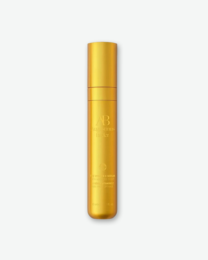 Augustinus Bader The Vitamin C Serum with Advanced TFC8 in a sleek 30ml (1 fl. oz.) metallic satin-gold cylindrical bottle.