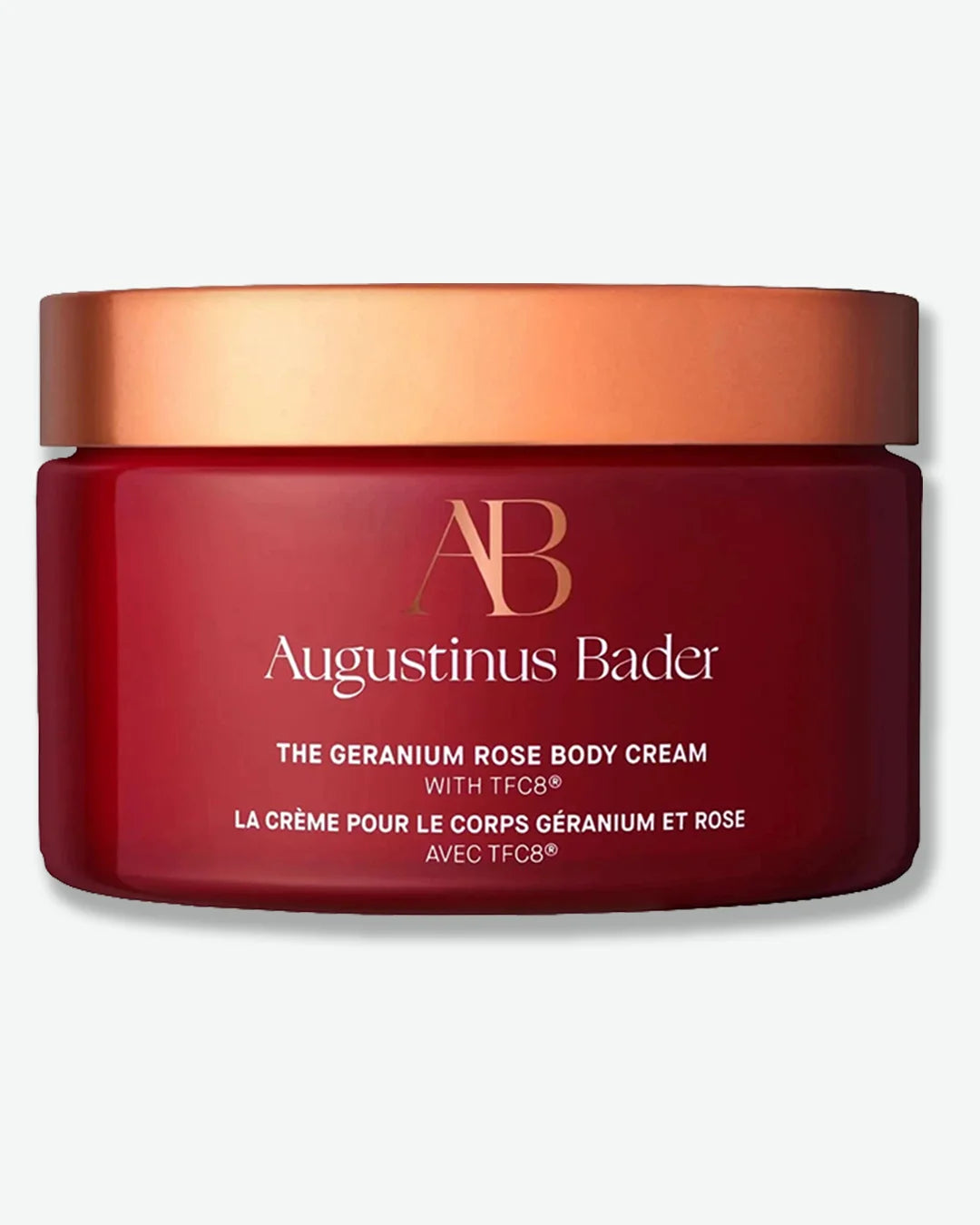 Red jar of Augustinus Bader geranium rose body cream with gold lid on a white background