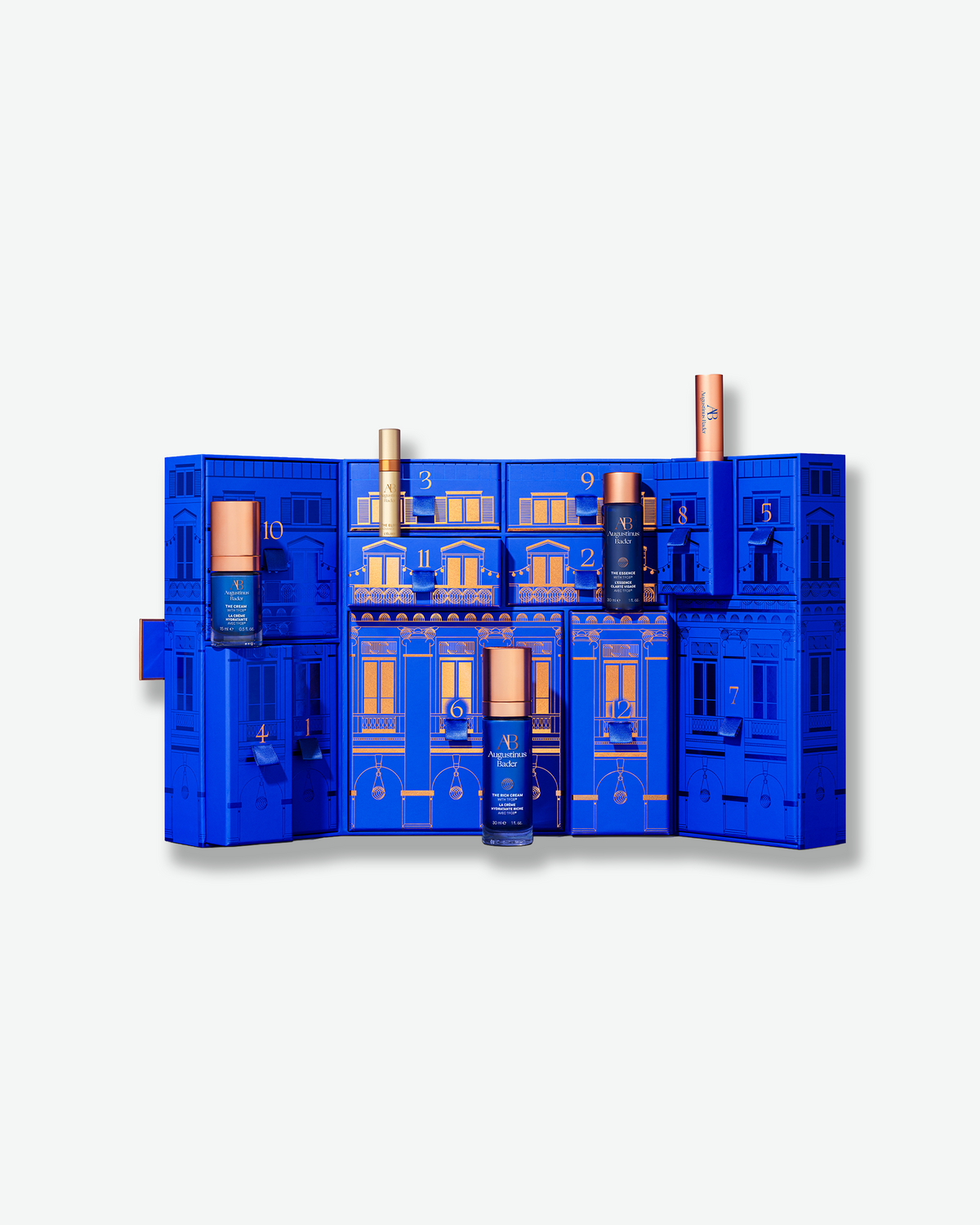 Open Augustinus Bader The 12 Days of Bader advent calendar with numbered compartments and select skincare products revealed.