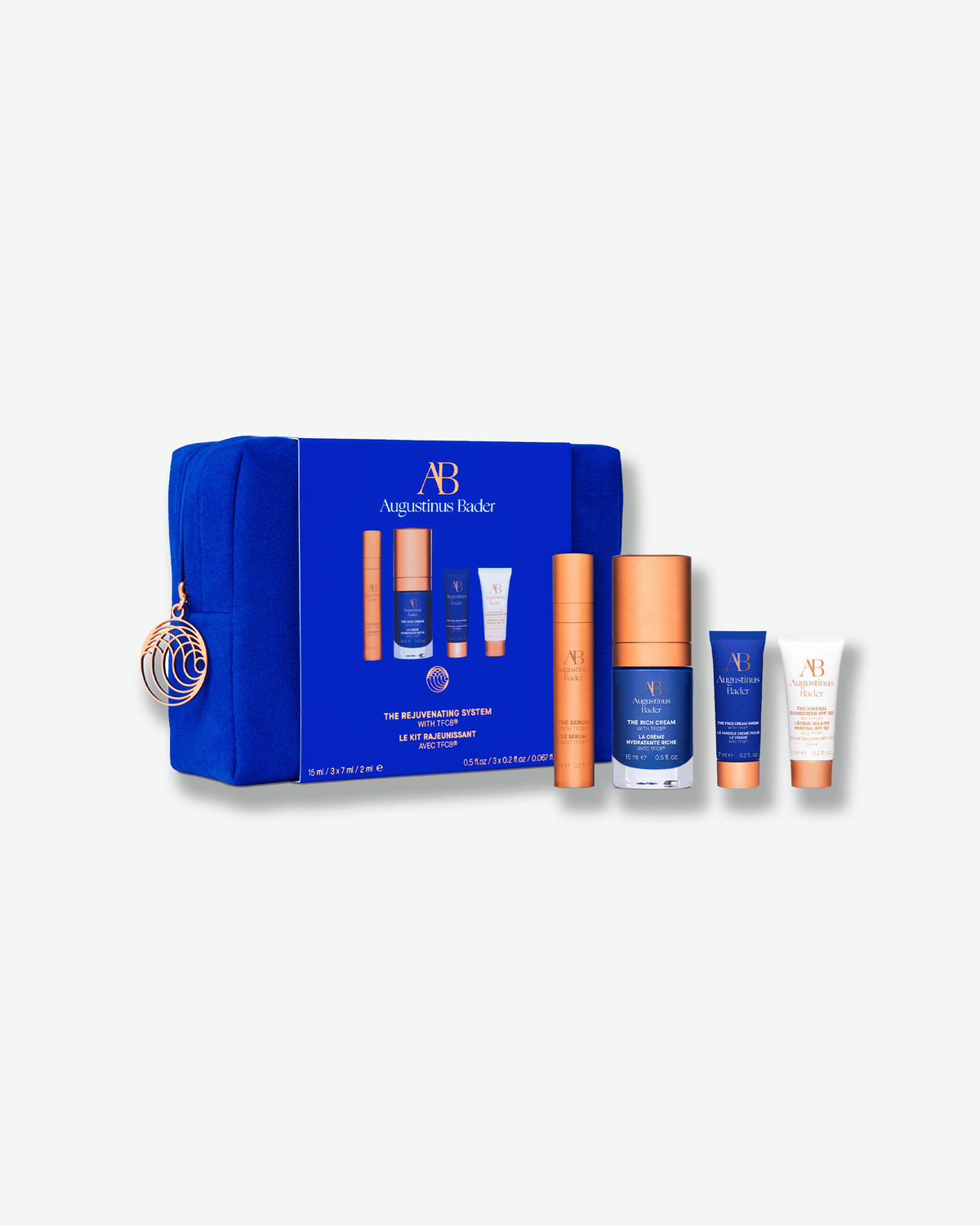 Augustinus Bader The Rejuvenating System featuring four skincare essentials displayed beside a blue travel case.